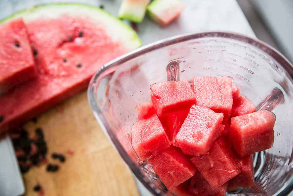 Fresh watermelon chunks in a blender.