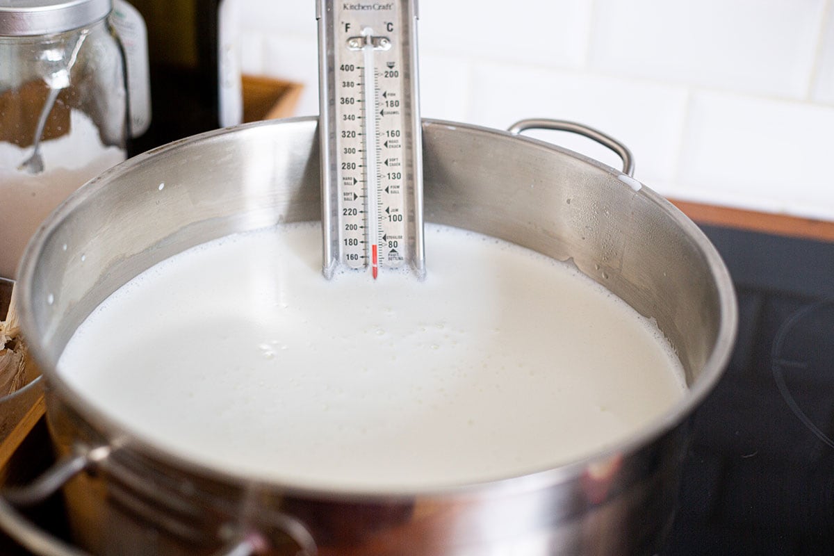 The milk for making queso fresco recipe heating up in a large pot.