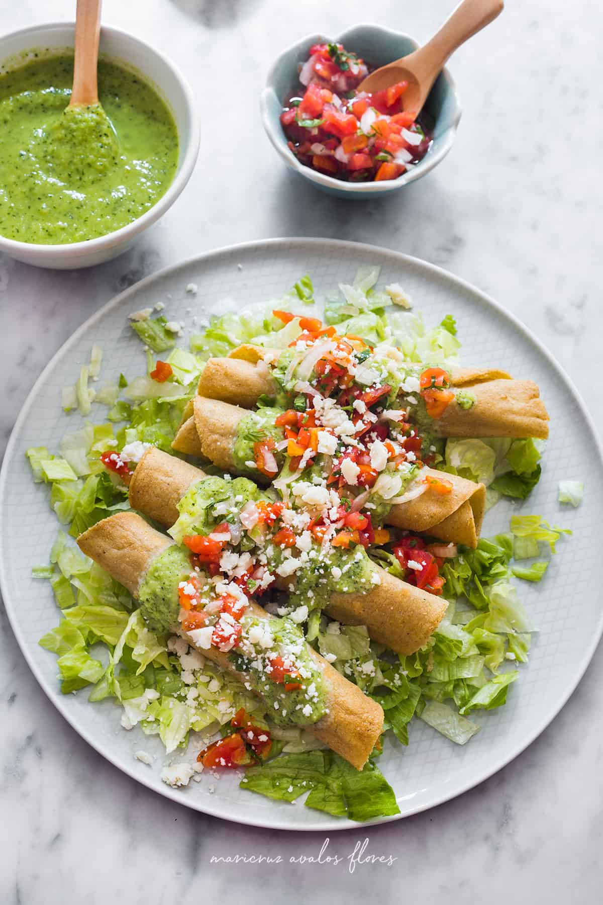Chicken rolled tacos served with lettuce, pico de gallo and guacamole salsa.