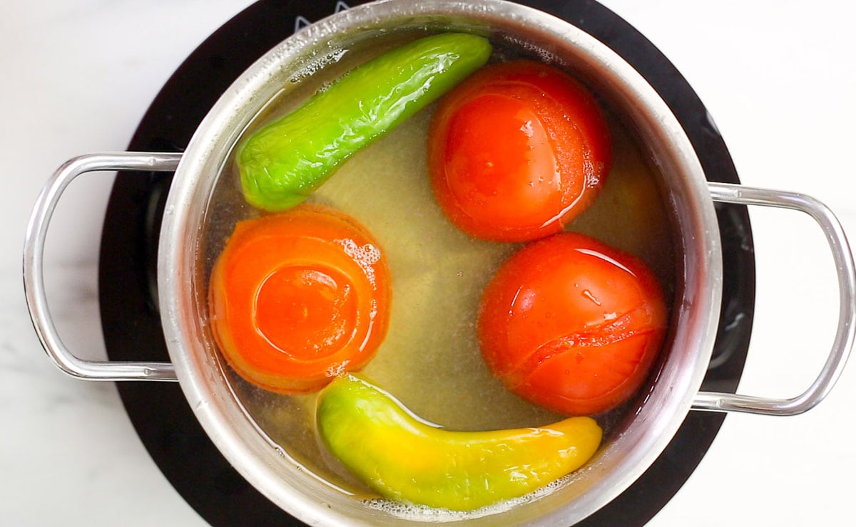 Tomatoes and chilies boiled in a saucepan.