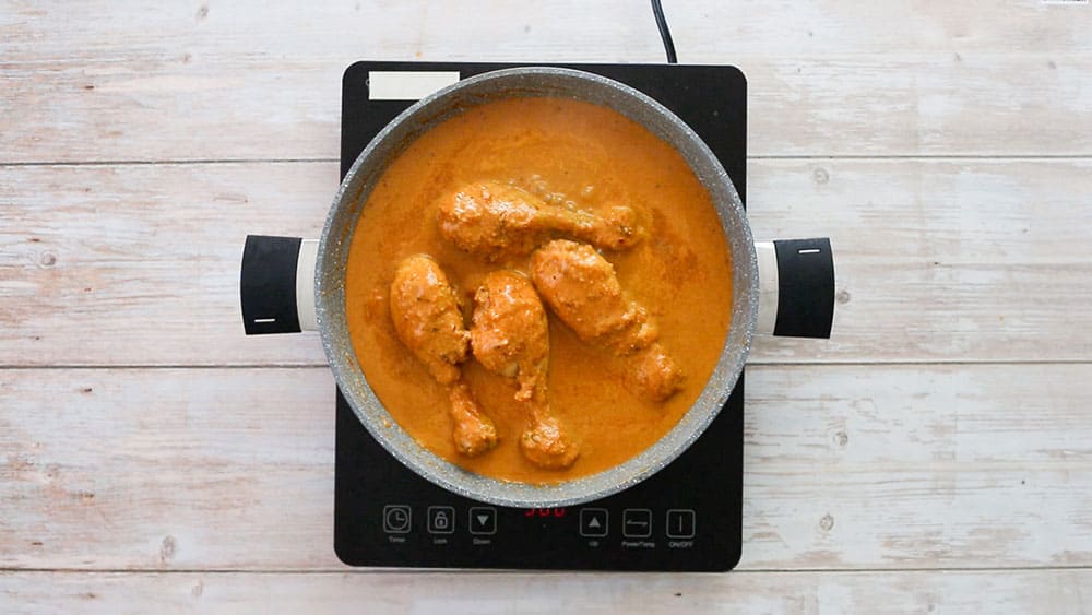 Cooking the peanut sauce with chicken.