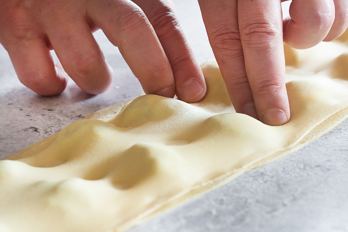 Pressing the dough with fingers to stick well.