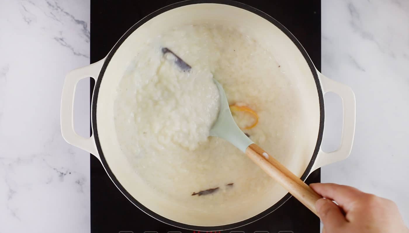 Mixing the arroz con leche with a spoon.
