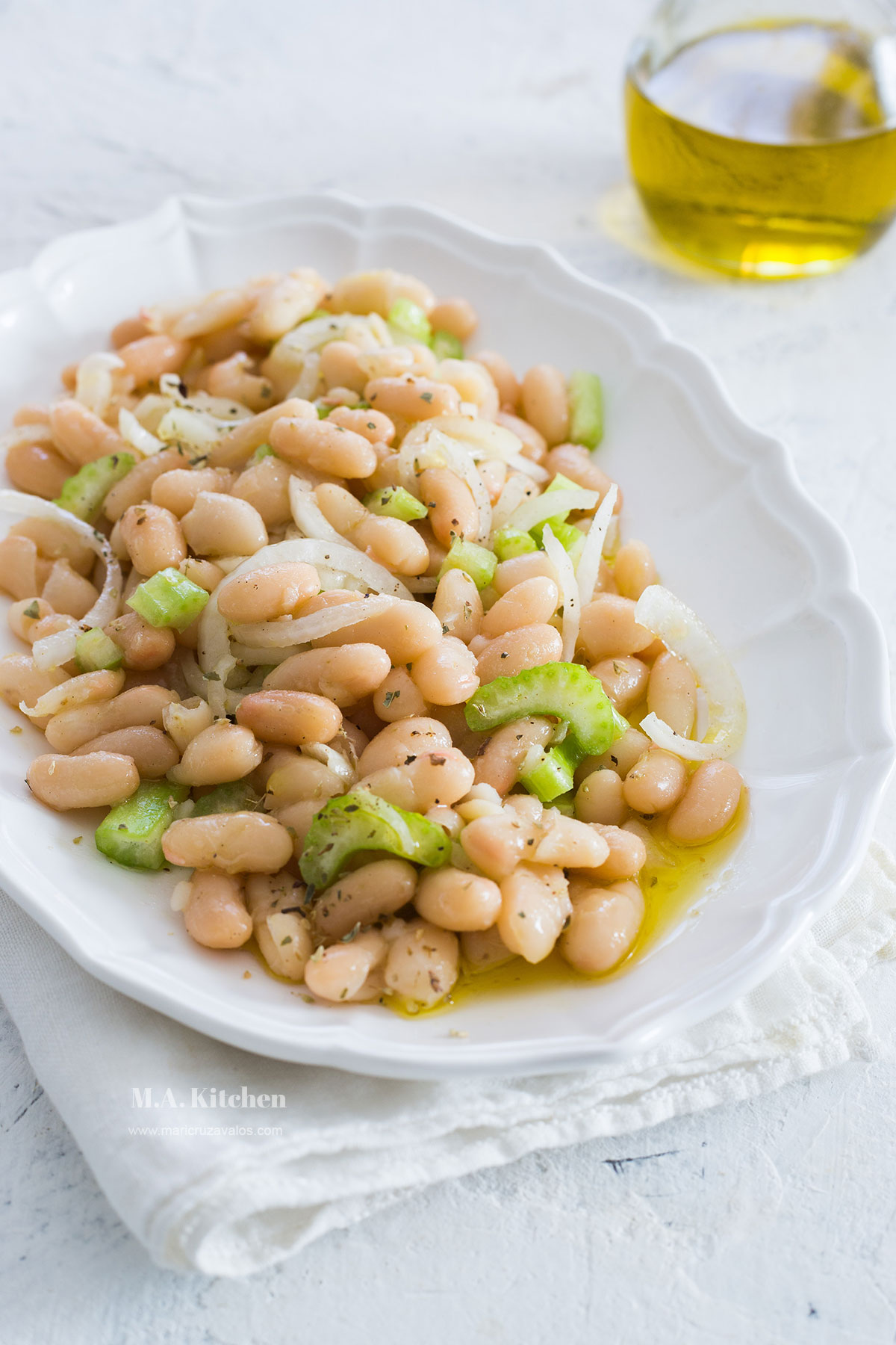 Authentic Italian cannellini beans salad served in a white plate.