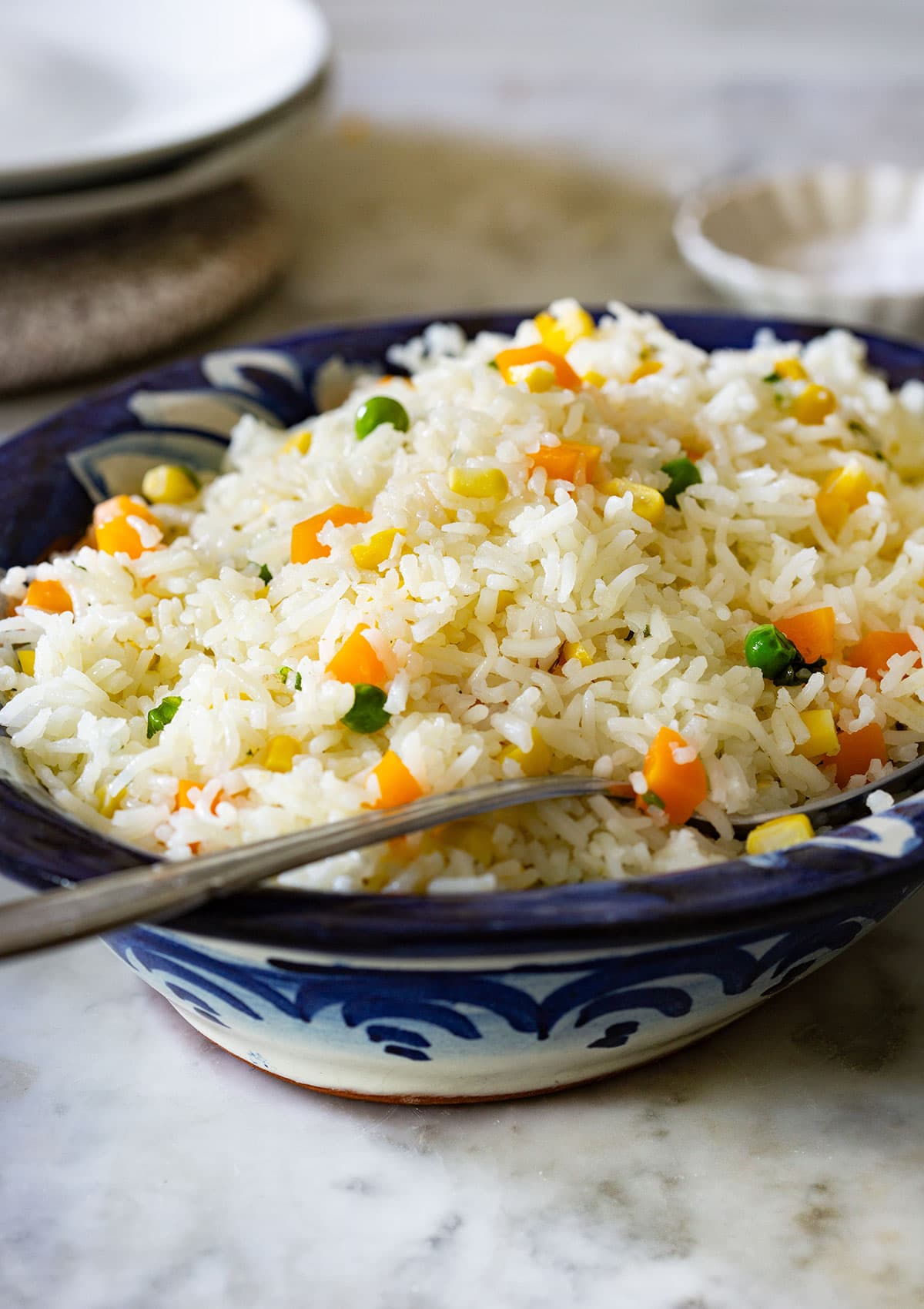 Mexican white rice, also known as arroz blanco or arroz primavera, served on a clay bowl.