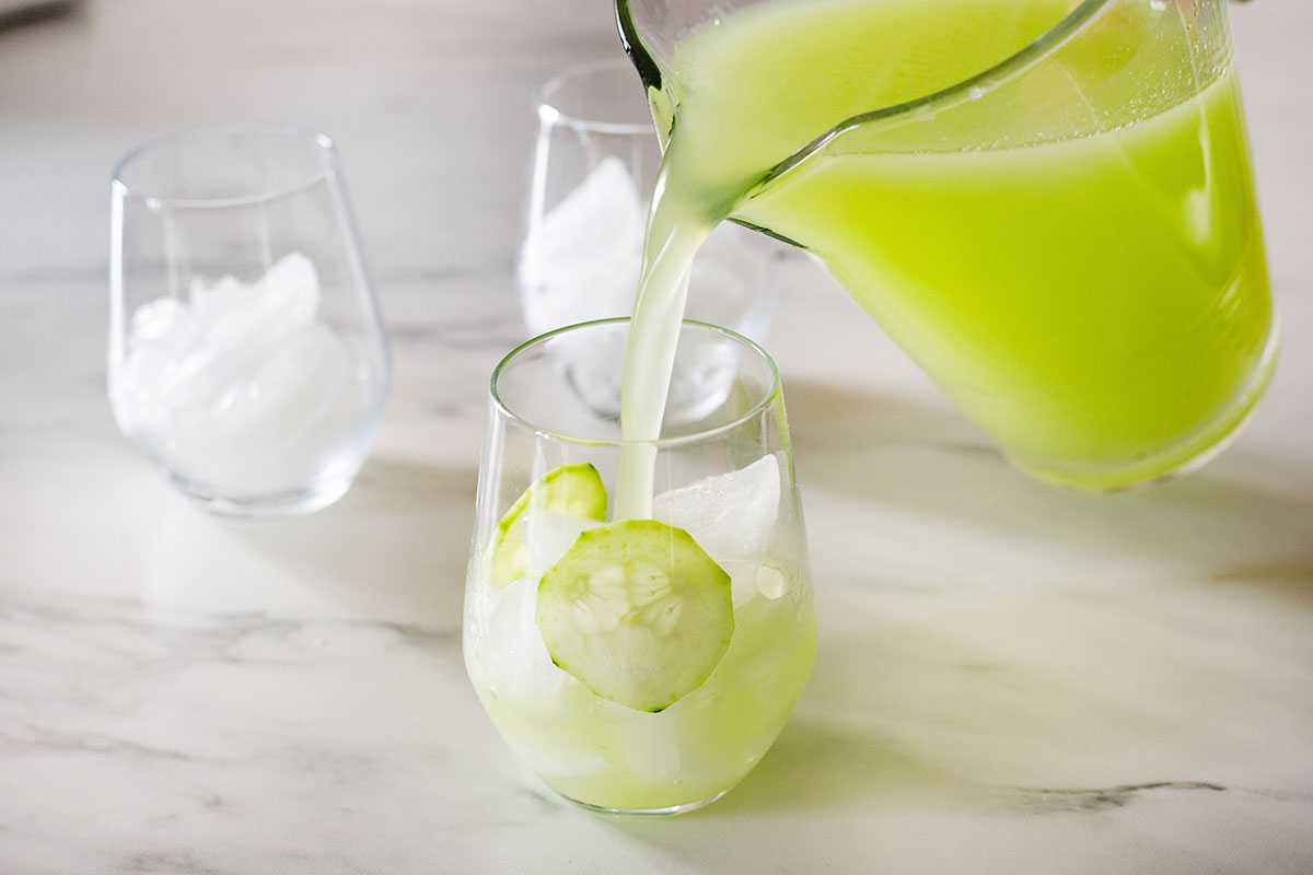 Serving agua de pepino in a glass with ice.