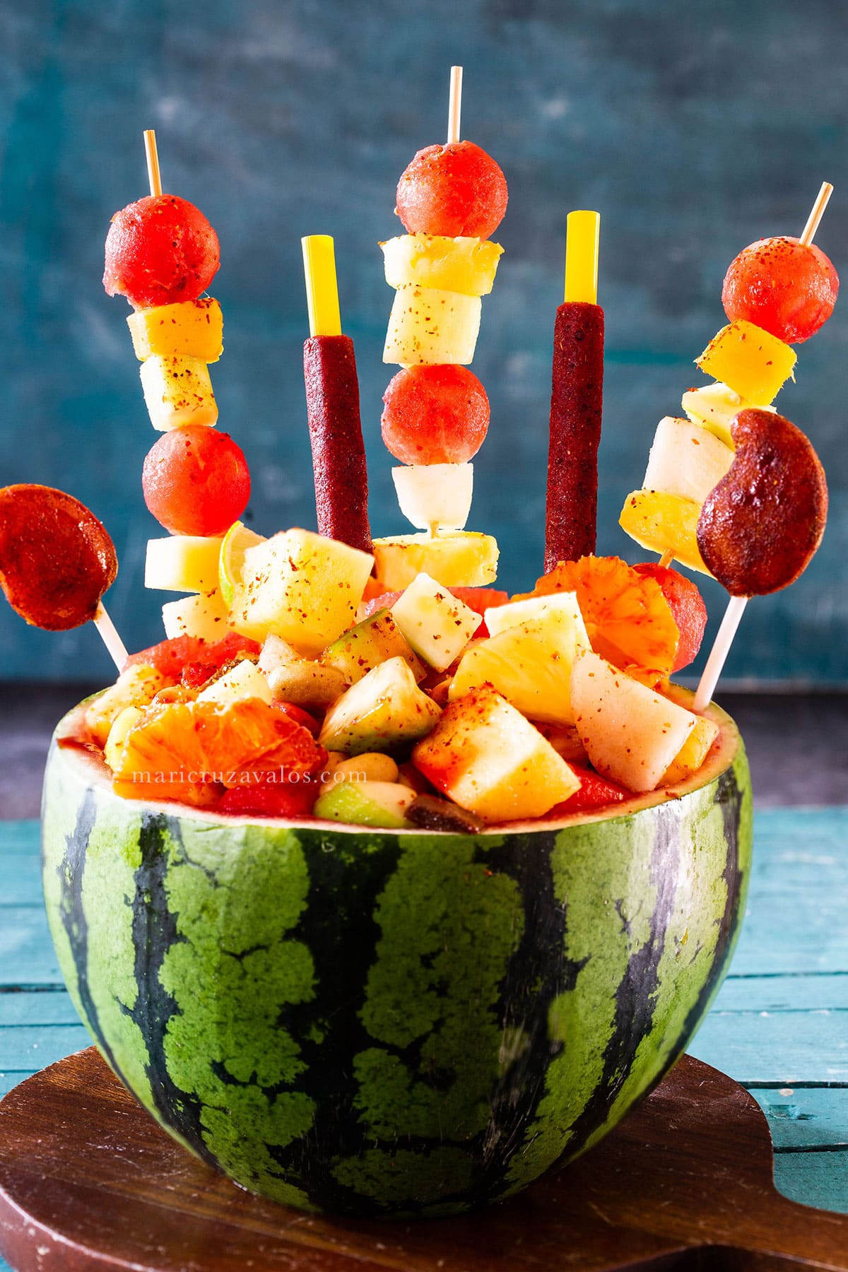 Sandia loca (crazy watermelon) decorated with fruit skewers and Mexican candies.