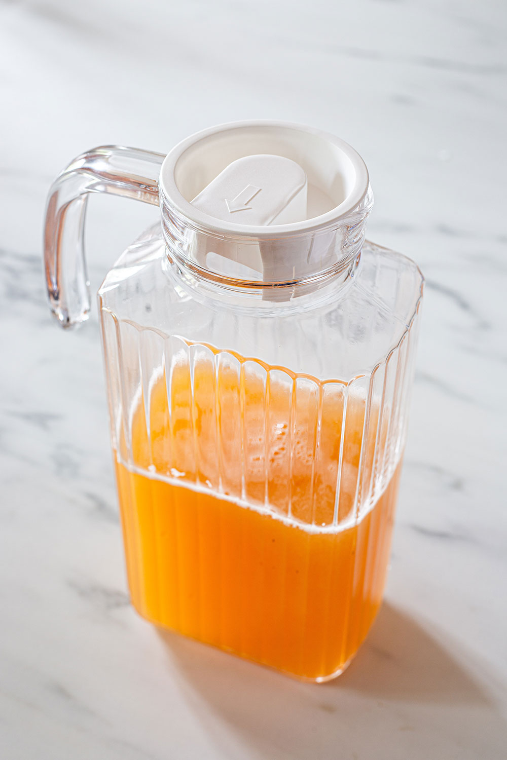 Agua de melon in a pitcher with lid.