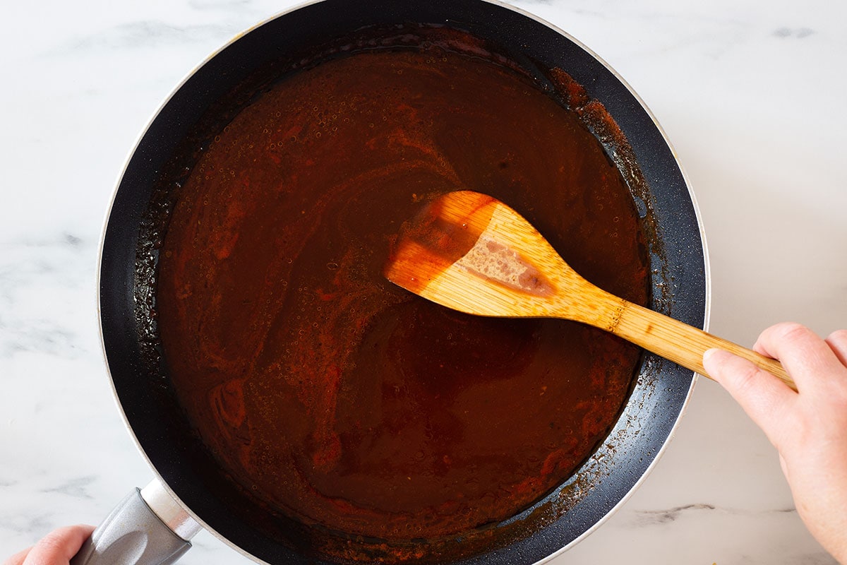 Stirring the bbq sauce on a pan.