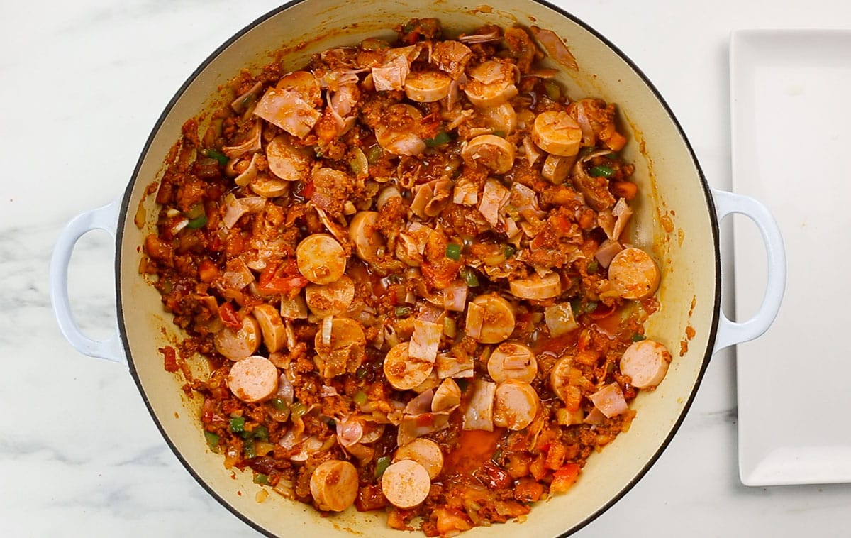 Sausage and ham added to the pan with the other ingredients.