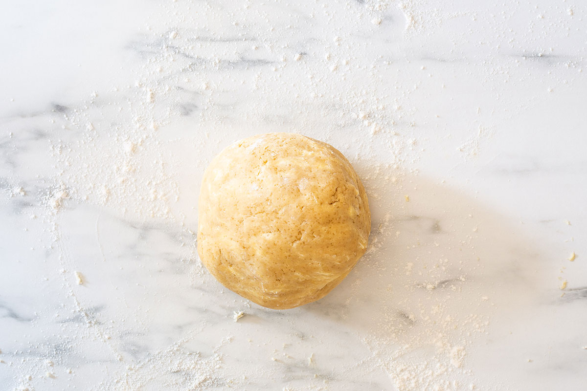 A dough ball on a marble surface.
