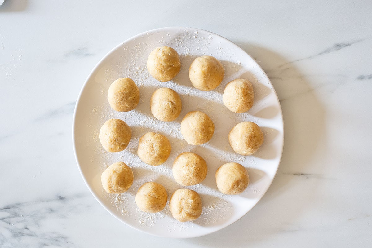 14 dough balls on a plate.