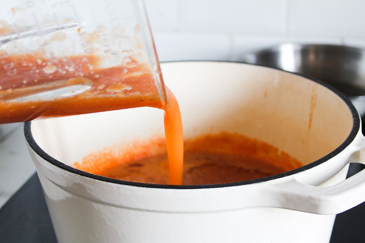 Adding tomato consome to the pot.