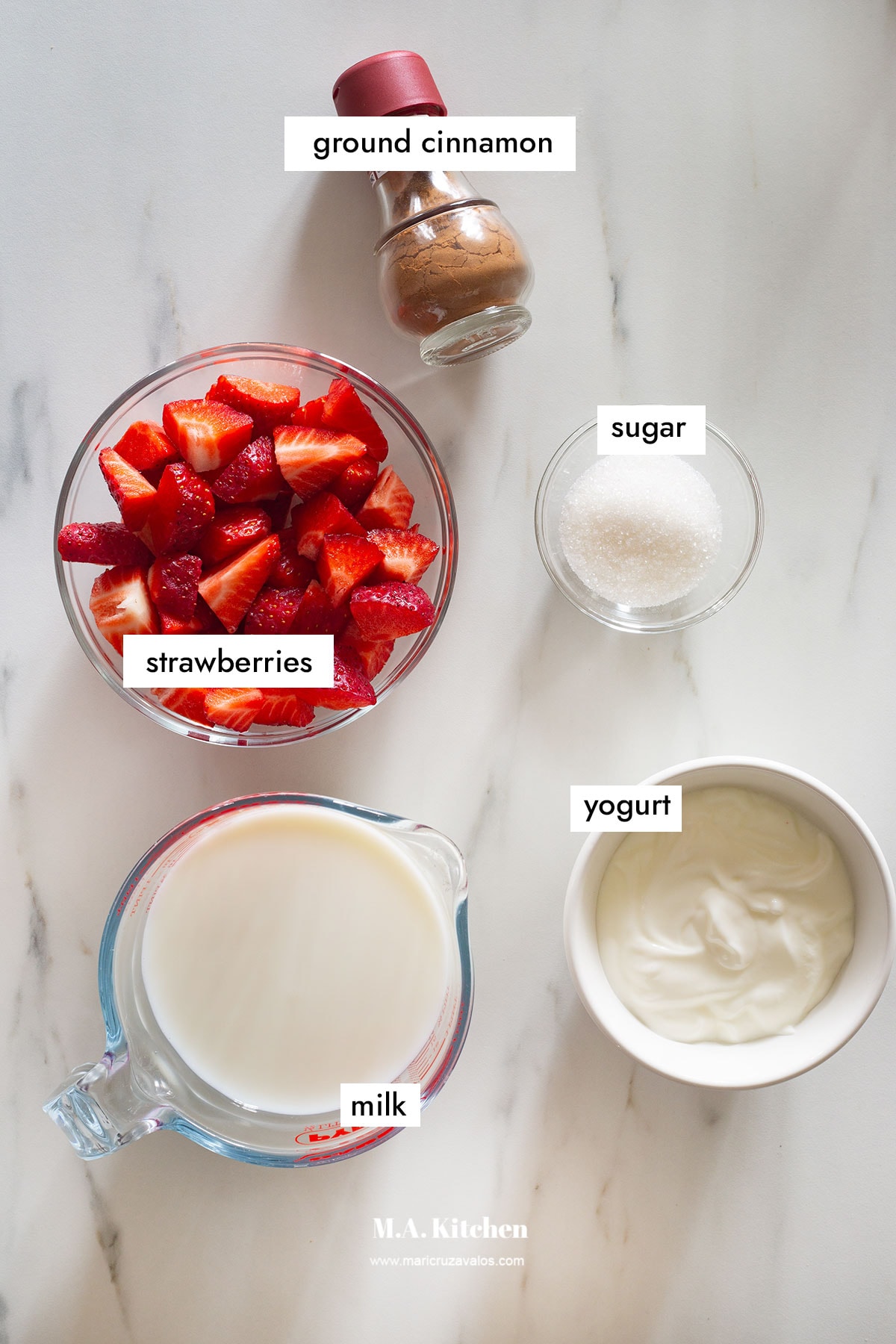 Ingredients for licuado de fresa in a white kitchen countertop.