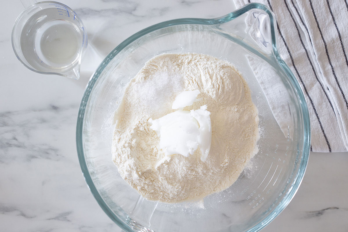 Flour, salt, and lard in a mixing bowl.