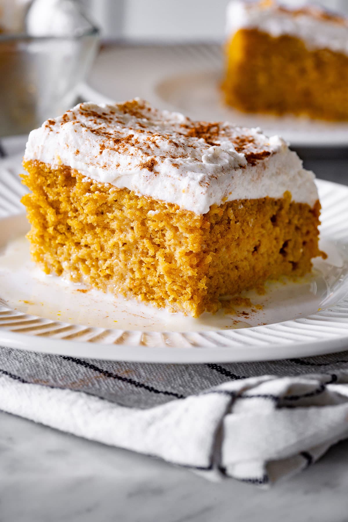 Pumpkin spice tres leches cake portion on a plate.