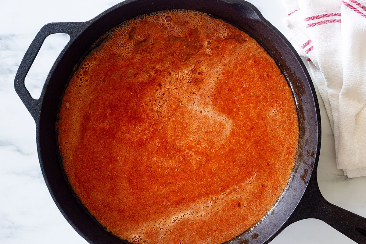 Chipotle sauce added to a skillet pan.