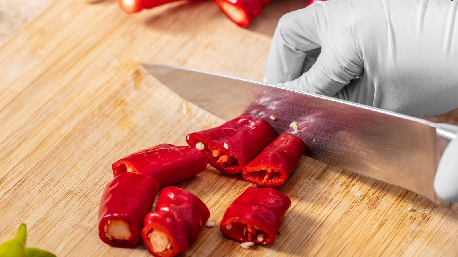 Cutting chilies with gloves closeup