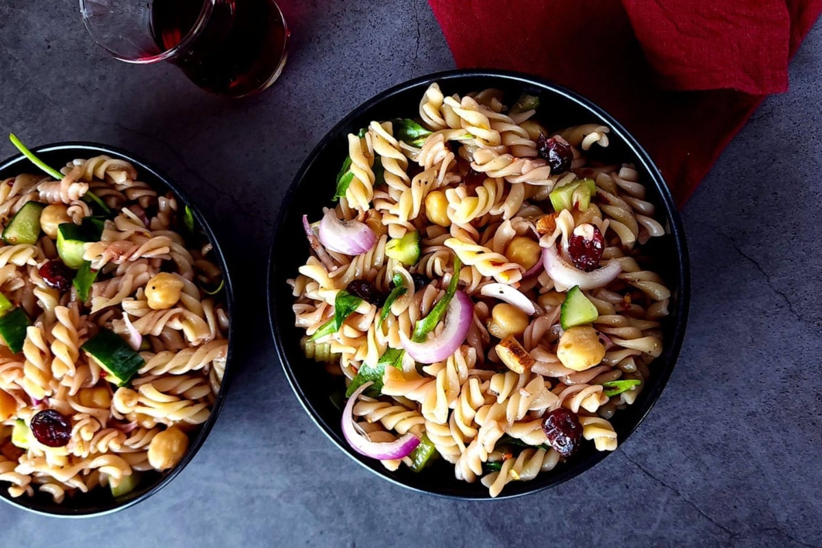 Pasta salad with dried cranberries on a bowl.