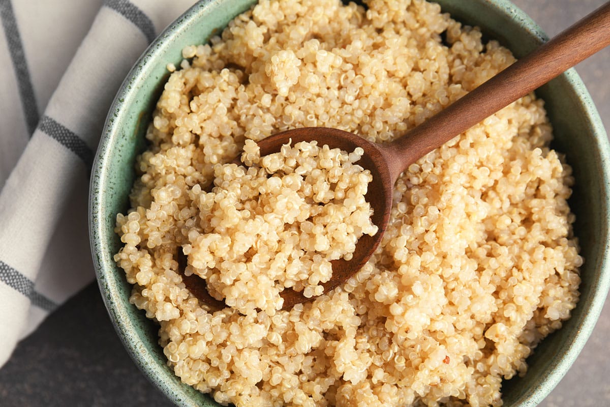 A large batch of cooked quinoa in a bowl.