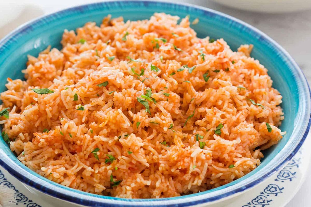 Mexican red rice in a turquoise plate.