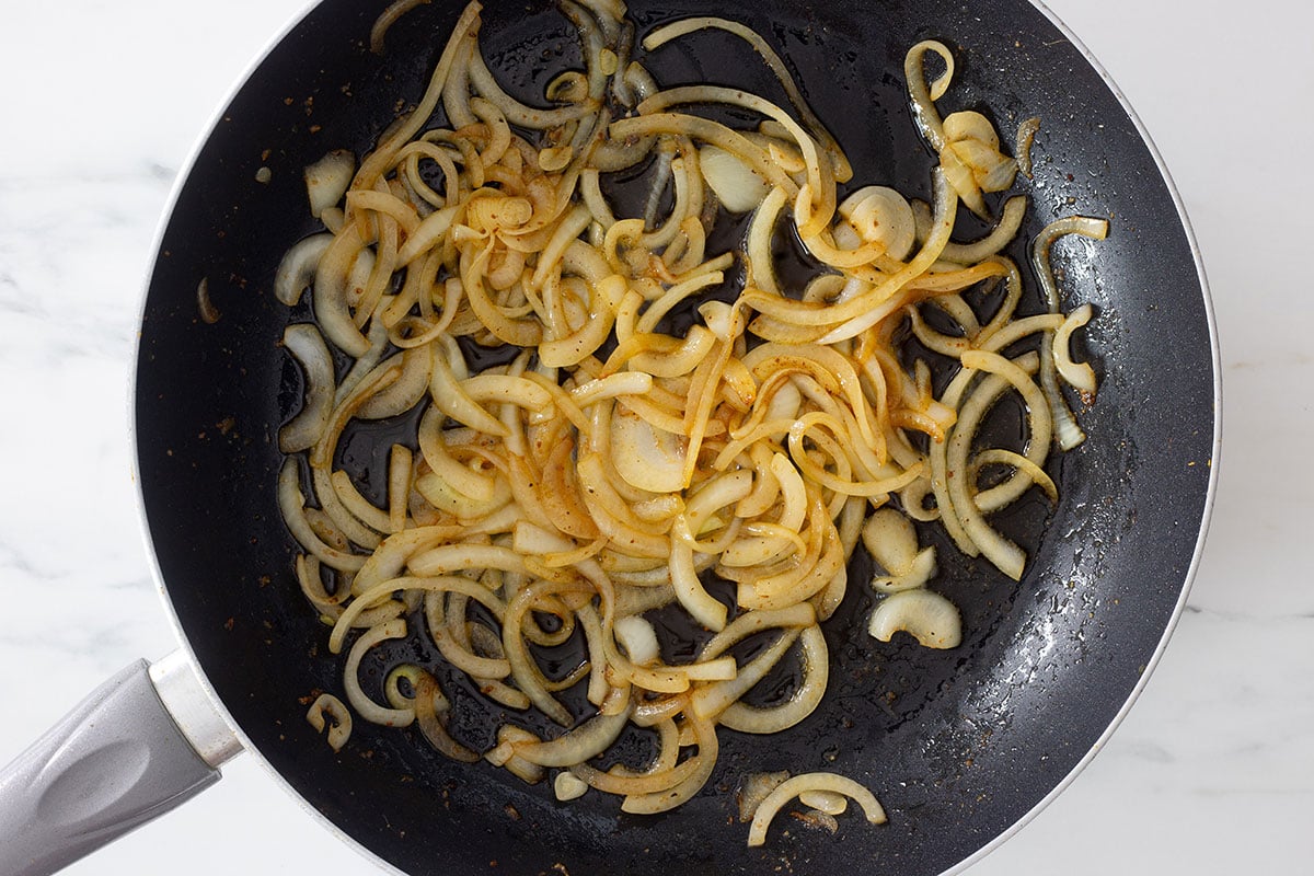 Slightly caramelized onions in a pan.