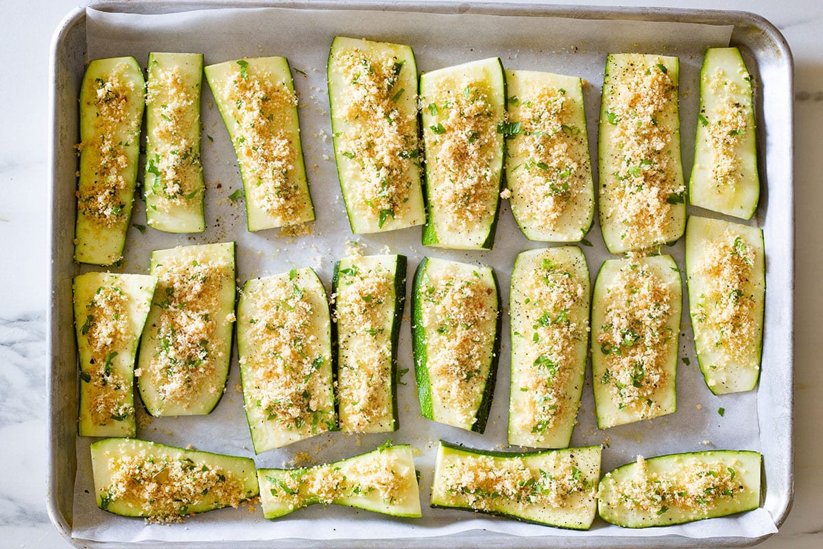Zucchine gratinate ready to be backed on a baking tray.