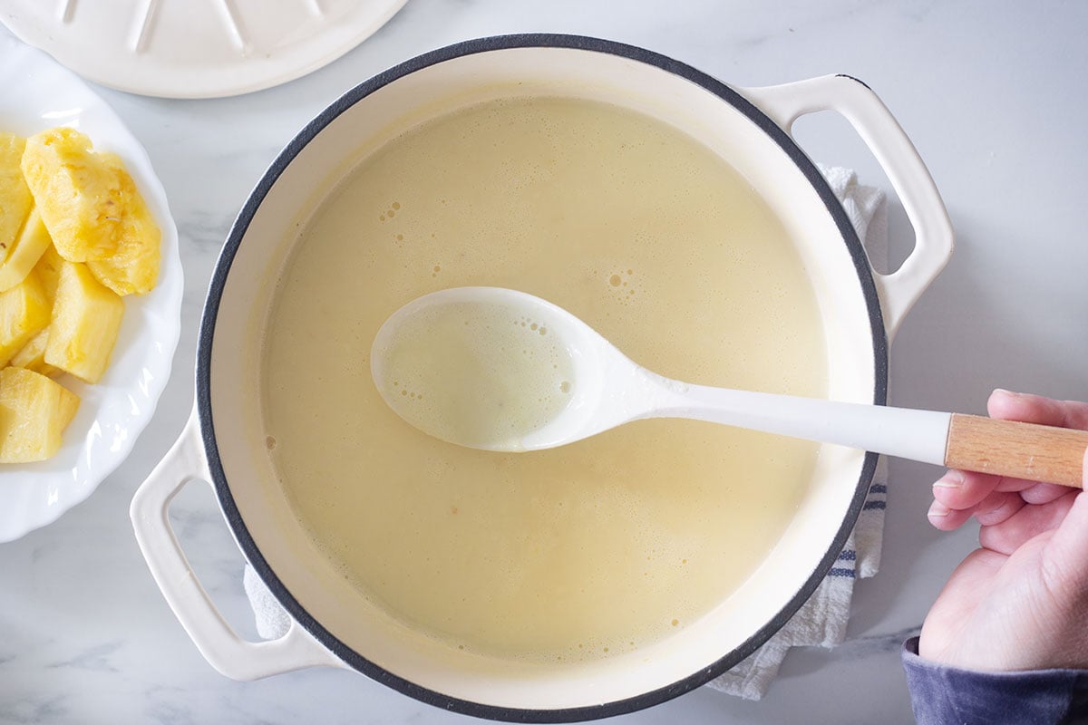 Showing the thick atole de pina with a spoon, ready to serve.