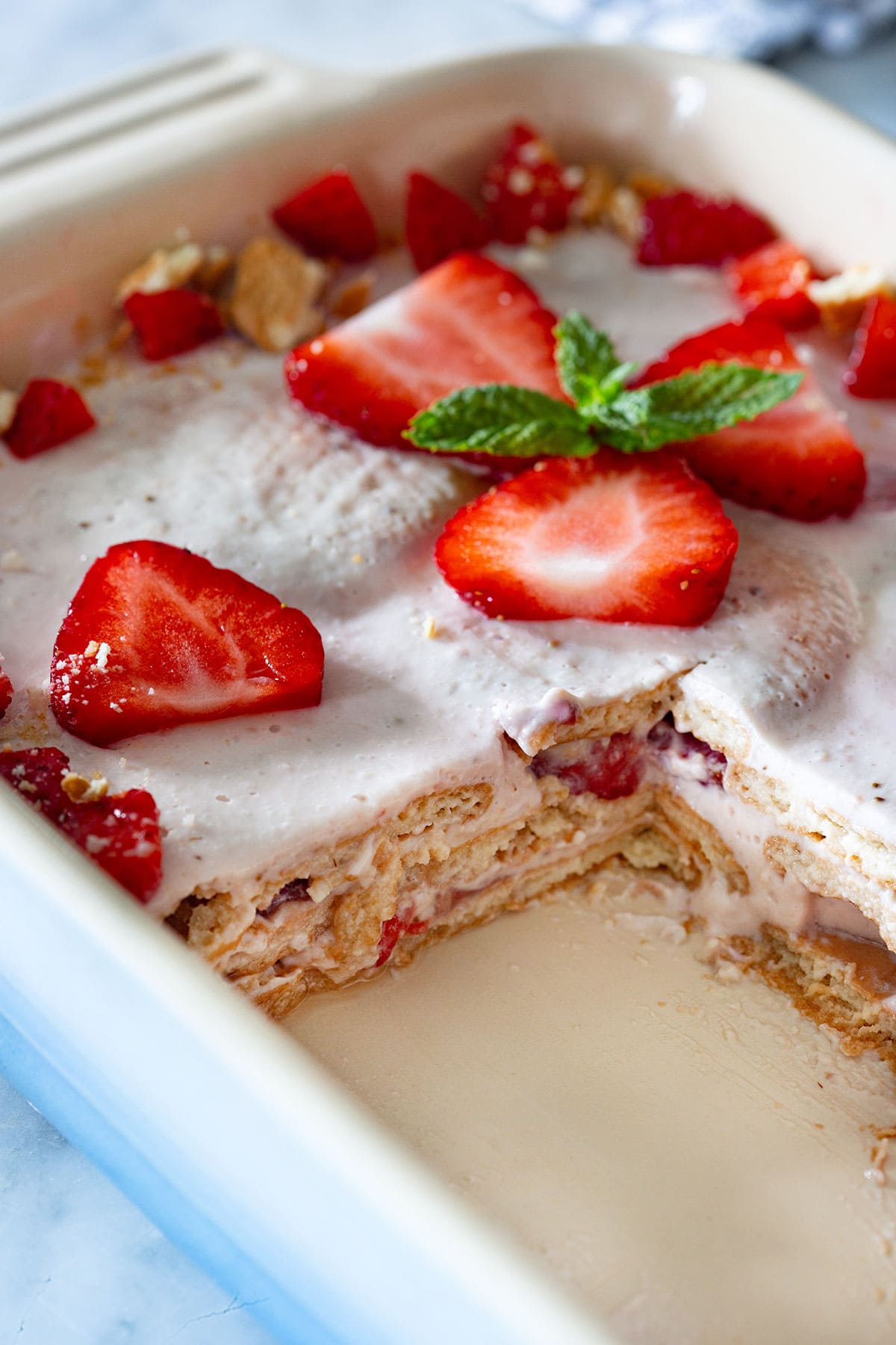 Carlota de Fresas with a portion removed in a baking dish.