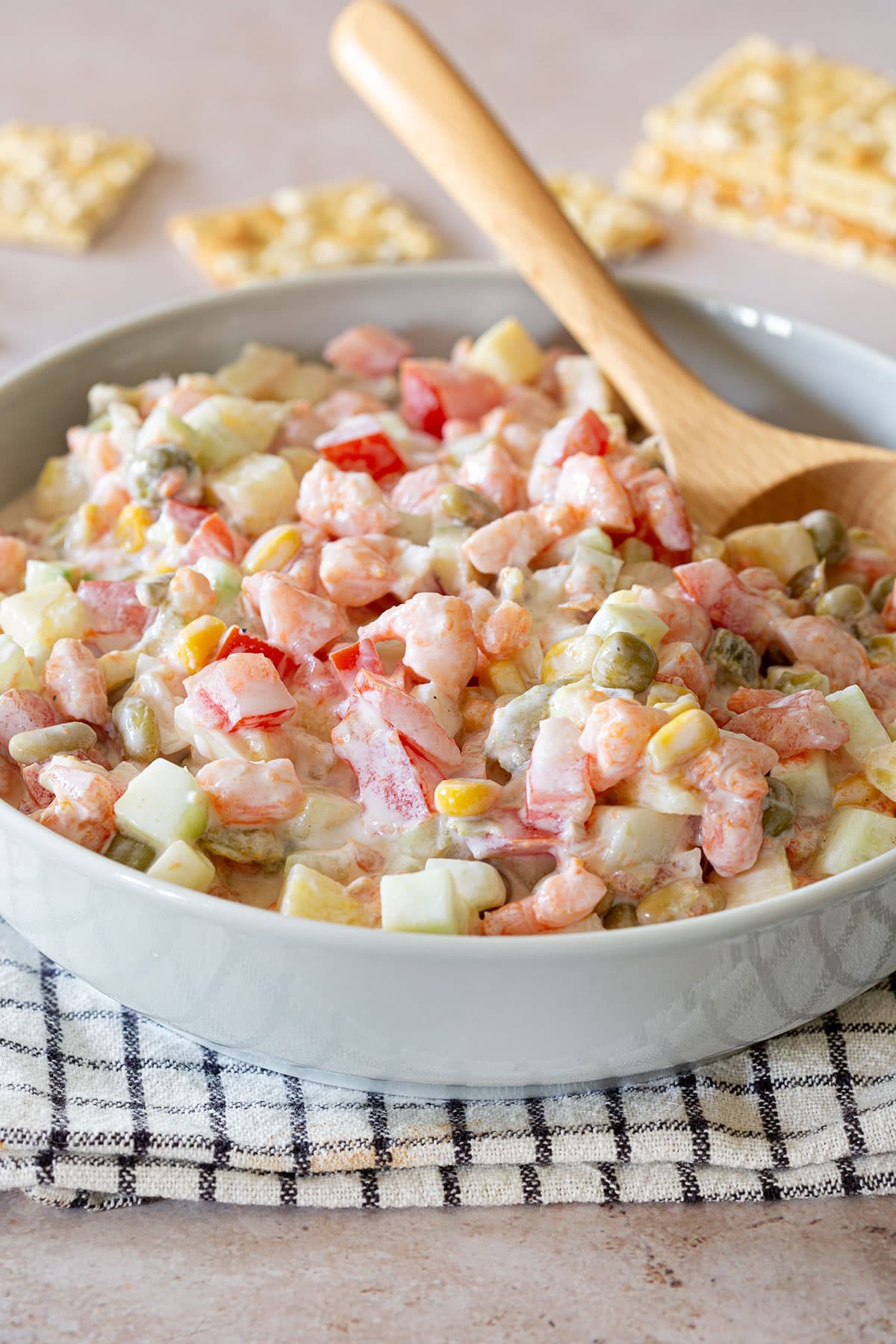 Ensalada de Camarones in a bowl with a wooden spoon.