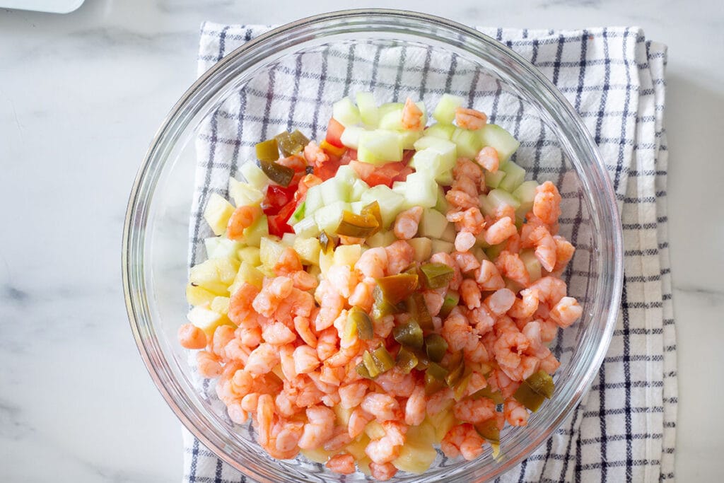 Shirmp, vegetables, and pineapple in a bowl.