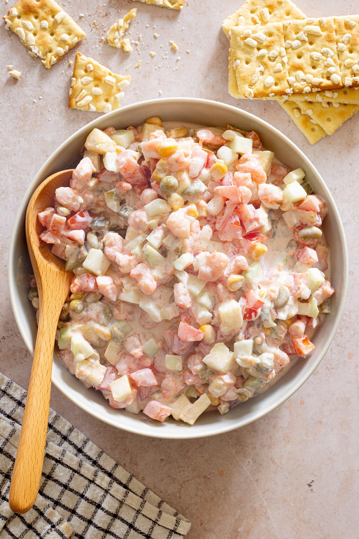 Creamy Ensalada de Camaron in a bowl with some saltine crackers scattered around.