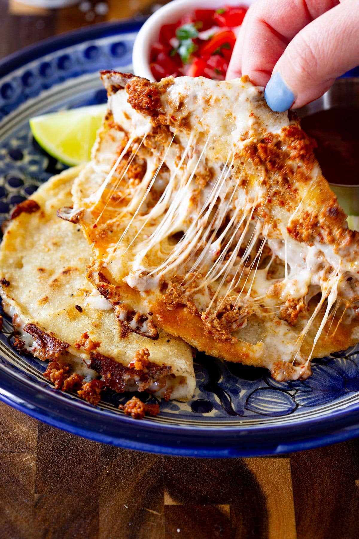 Opening a chorizo quesadilla to see the gooey, melty cheese and crispy chorizo inside.