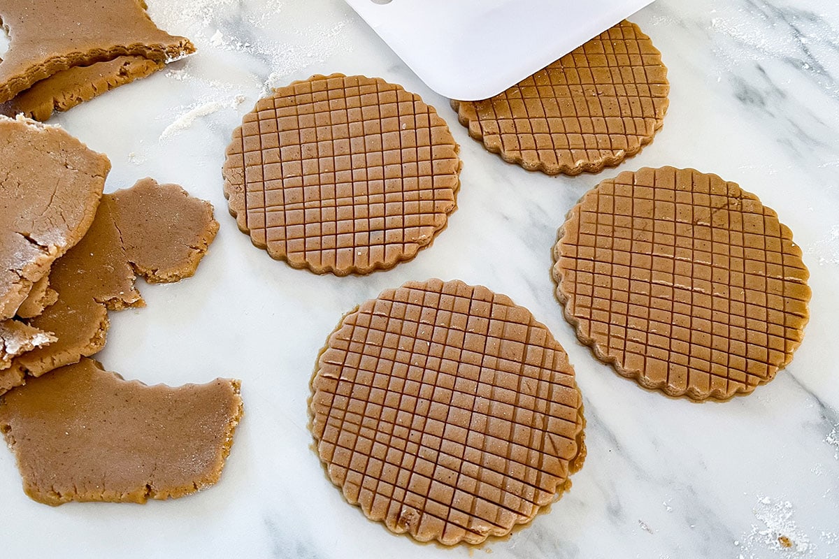 Galletas de canela dough with a grid pattern cut into the surface before baking.