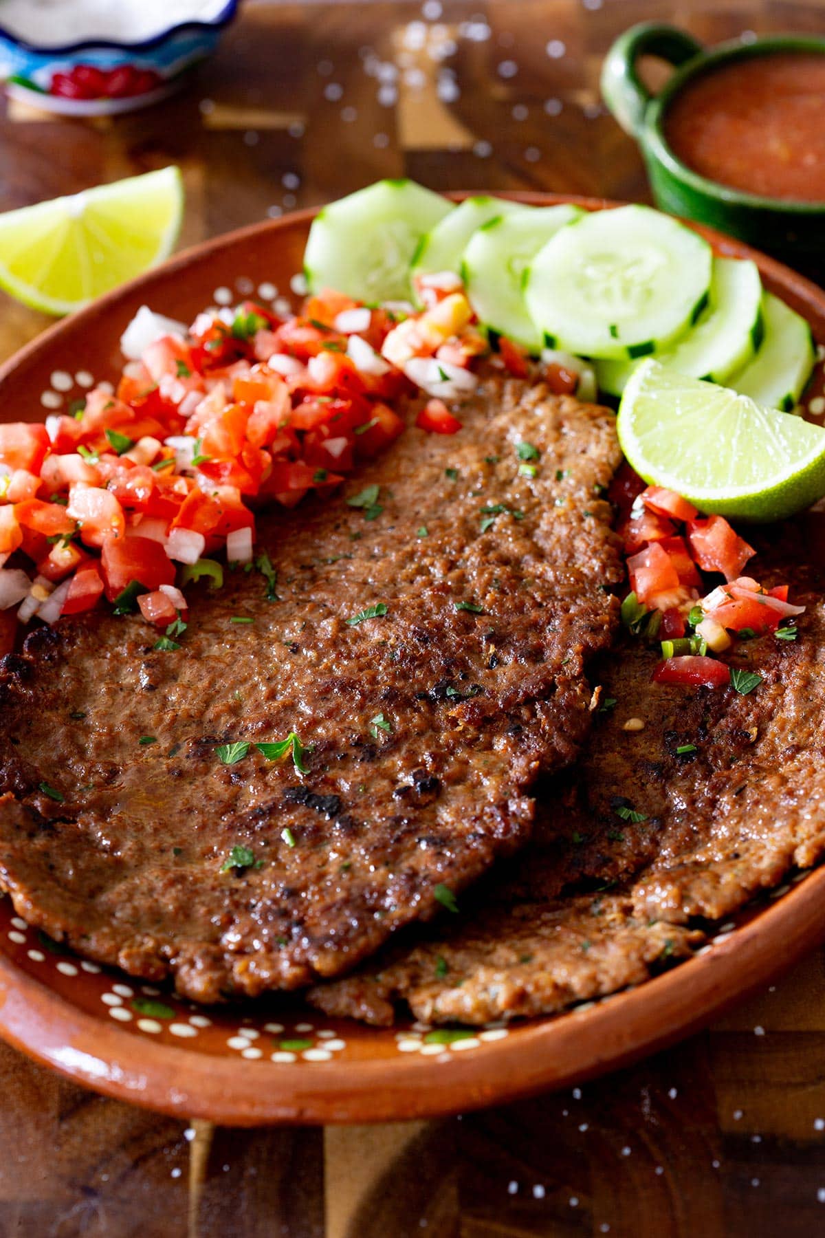 Mexican pacholas served with pico de gallo and slices of cucumber.
